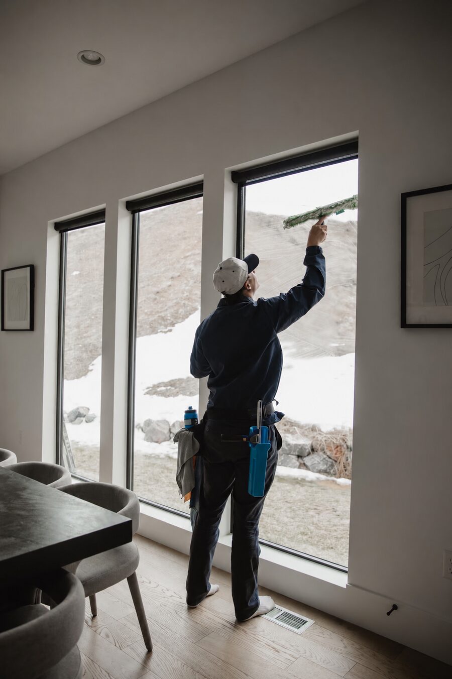 Sterling Home Services technician cleaning interior windows